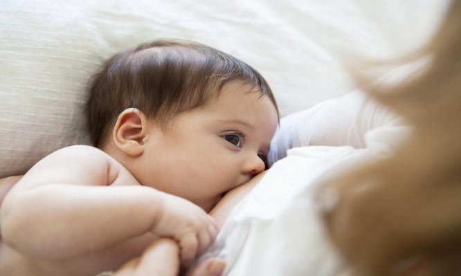 Mother breast-feeding baby girl