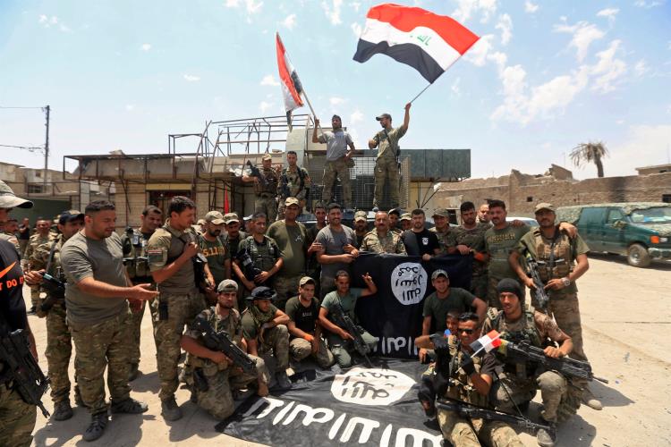 Members of the Emergency Response Division celebrate in the Old City of Mosul