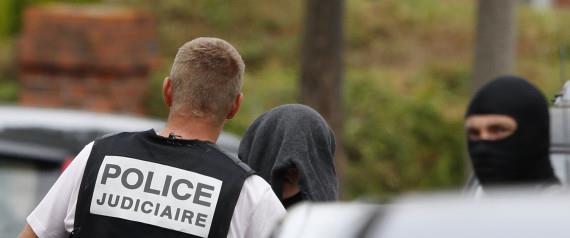 French judicial inverstigating police apprehends a man during a raid after a hostage-taking in the church in Saint-Etienne-du-Rouvray near Rouen in Normandy